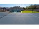 Backyard featuring a pool, gazebo, artificial grass and tennis court with benches in a well-maintained space at 8228 Fulton Ranch St, Las Vegas, NV 89131