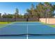 The image is of a blue and green tennis court with a net, basketball hoop, and walls on all sides at 8228 Fulton Ranch St, Las Vegas, NV 89131
