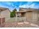 The backyard is enclosed with a rod iron fence and features rock landscaping with a covered patio at 8525 Festival Dr, Las Vegas, NV 89134