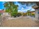 Landscaped backyard with low-maintenance gravel and a covered patio area at 8525 Festival Dr, Las Vegas, NV 89134