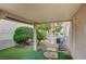 This backyard has artificial turf, rock landscaping, a covered patio, and stepping stones leading to the gate at 8525 Festival Dr, Las Vegas, NV 89134