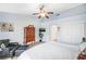 Bedroom with a tall dresser, closet, and leather chair, featuring neutral walls at 8525 Festival Dr, Las Vegas, NV 89134