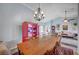Open-concept dining room with high ceilings and view of the living area, featuring a prominent china cabinet at 8525 Festival Dr, Las Vegas, NV 89134