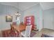 Dining room boasts high ceilings, a decorative chandelier, and an adjacent bright red china cabinet at 8525 Festival Dr, Las Vegas, NV 89134