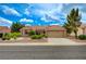 Charming single-story home featuring a tile roof, desert landscaping, and an attached two-car garage at 8525 Festival Dr, Las Vegas, NV 89134