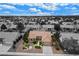 An exterior elevation of a one-story home with a well-manicured lawn and desert landscaping at 8525 Festival Dr, Las Vegas, NV 89134