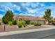 Attractive single-story home showcasing desert landscaping, a tile roof, and an attached two-car garage at 8525 Festival Dr, Las Vegas, NV 89134