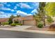 Inviting single-story home with a tile roof, well-maintained landscaping, and a spacious two-car garage at 8525 Festival Dr, Las Vegas, NV 89134