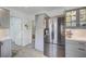 Kitchen with stainless steel fridge, gray cabinets, tile backsplash, and wood-look tile flooring at 8525 Festival Dr, Las Vegas, NV 89134