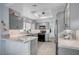 Updated kitchen with gray cabinets, white marble countertops, tile backsplash and stainless steel appliances at 8525 Festival Dr, Las Vegas, NV 89134