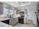 Bright kitchen features gray cabinets, stone countertops, stainless steel appliances, and a large window at 8525 Festival Dr, Las Vegas, NV 89134