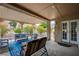 Covered patio with comfortable seating, a patterned rug and access to the home's interior at 8525 Festival Dr, Las Vegas, NV 89134