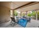 Inviting covered patio featuring stylish outdoor seating and a patterned rug at 8525 Festival Dr, Las Vegas, NV 89134