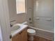 Bathroom featuring a tub with shower and tile surround, vanity with sink, and toilet at 8688 Tomnitz Ave # 101, Las Vegas, NV 89178
