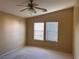Bedroom with neutral carpet and a ceiling fan with natural light at 8688 Tomnitz Ave # 101, Las Vegas, NV 89178
