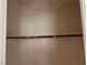 An interior view of an empty closet with one wooden support rod inside at 8688 Tomnitz Ave # 101, Las Vegas, NV 89178