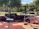 Outdoor exercise area featuring various workout equipment surrounded by shady trees and manicured lawns at 8688 Tomnitz Ave # 101, Las Vegas, NV 89178