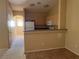 Functional kitchen featuring laminate countertops, wood cabinetry, and appliances at 8688 Tomnitz Ave # 101, Las Vegas, NV 89178