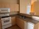 Functional kitchen featuring laminate countertops, wood cabinetry, and appliances at 8688 Tomnitz Ave # 101, Las Vegas, NV 89178