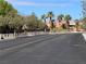 A peaceful street view with palm trees and well-maintained landscaping at 8688 Tomnitz Ave # 101, Las Vegas, NV 89178