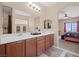 Bathroom featuring double sinks and an arched entryway to bedroom at 9457 Alma Ridge Ave, Las Vegas, NV 89178