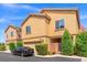 Charming two-story townhome featuring a one car garage, desert landscaping, and a welcoming gated entryway at 9457 Alma Ridge Ave, Las Vegas, NV 89178