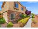 Well-maintained home exterior with stone accents and verdant landscaping at 9457 Alma Ridge Ave, Las Vegas, NV 89178