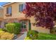 Charming home entrance with a stone accent wall and mature landscaping at 9457 Alma Ridge Ave, Las Vegas, NV 89178