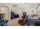 Spacious game room featuring comfortable seating, shelving units, and fun arcade games at 9457 Alma Ridge Ave, Las Vegas, NV 89178