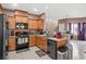This beautiful kitchen includes wood cabinets, granite countertops, and stainless steel appliances at 9457 Alma Ridge Ave, Las Vegas, NV 89178