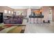 Open floor plan with tile flooring, living room seating, and kitchen bar at 9457 Alma Ridge Ave, Las Vegas, NV 89178