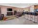 Open living space showcasing tile flooring, comfortable seating, and kitchen bar at 9457 Alma Ridge Ave, Las Vegas, NV 89178