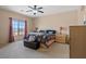 Bright main bedroom featuring a ceiling fan, large window and neutral carpet at 9457 Alma Ridge Ave, Las Vegas, NV 89178