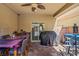 Relaxing covered patio with a ceiling fan, brick flooring, and outdoor seating, perfect for entertaining at 9457 Alma Ridge Ave, Las Vegas, NV 89178