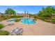 Community pool area with lounge chairs and shade, perfect for relaxation at 9457 Alma Ridge Ave, Las Vegas, NV 89178