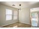 Bright dining area with tile floors, modern light fixture, and sliding glass door access at 9535 Golden Scots Ct, Las Vegas, NV 89123