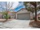Charming home featuring a two-car garage and a well-maintained front yard at 9535 Golden Scots Ct, Las Vegas, NV 89123