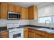 Well-equipped kitchen featuring wood cabinets, gas range, and modern appliances at 9535 Golden Scots Ct, Las Vegas, NV 89123