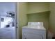 This laundry room features a white washing machine and shelf at 9535 Golden Scots Ct, Las Vegas, NV 89123