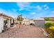 A spacious backyard with rock landscaping, lush plants, and a small shed at 988 Flapjack Dr, Henderson, NV 89014