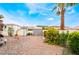 A spacious backyard features rock landscaping and a small shed amidst lush plants at 988 Flapjack Dr, Henderson, NV 89014