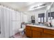 A full bathroom with granite countertops, tile flooring, and shower with curtain at 988 Flapjack Dr, Henderson, NV 89014