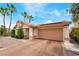 Attractive single-story house with palm trees, desert landscaping, and a two-car garage at 988 Flapjack Dr, Henderson, NV 89014