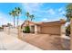 Beautiful single-story home with palm trees, solar panels, and a well-manicured lawn at 988 Flapjack Dr, Henderson, NV 89014