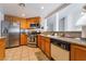 Well-lit kitchen features stainless steel appliances, granite countertops, and honey-colored wood cabinetry at 988 Flapjack Dr, Henderson, NV 89014