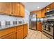 A kitchen featuring granite countertops, stainless steel appliances, and tile flooring at 988 Flapjack Dr, Henderson, NV 89014