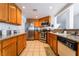 Traditional kitchen featuring oak cabinets, stainless steel appliances, and granite countertops at 988 Flapjack Dr, Henderson, NV 89014
