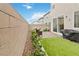 Backyard area featuring artificial turf, pavers, and a gas grill at 10190 Natural Anchor St, Las Vegas, NV 89166
