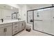 Bright bathroom featuring a double vanity, modern fixtures, and a spacious shower with glass enclosure at 10190 Natural Anchor St, Las Vegas, NV 89166
