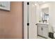 Bright half bath with grey vanity, mirror, and modern fixtures at 10190 Natural Anchor St, Las Vegas, NV 89166